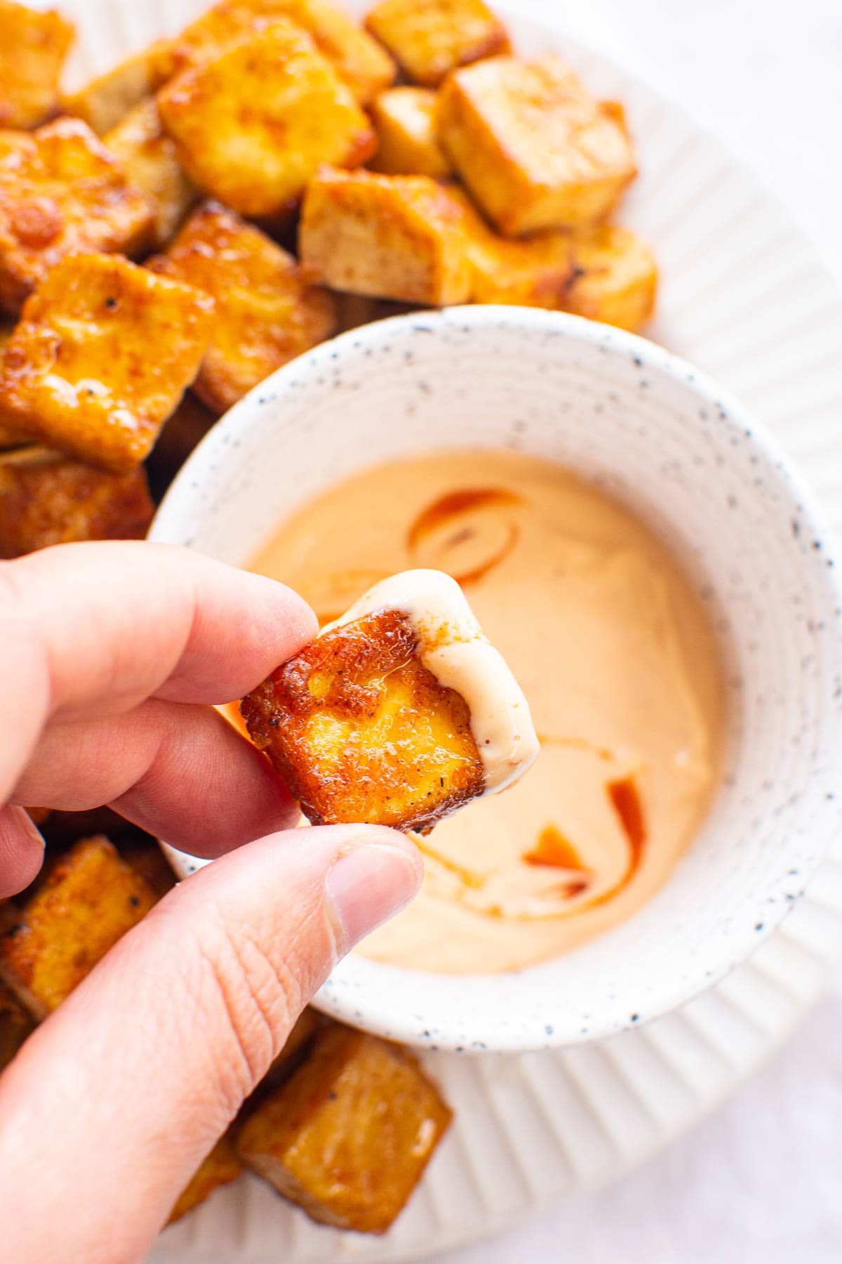 Air fryer tofu dipped in spicy mayo.