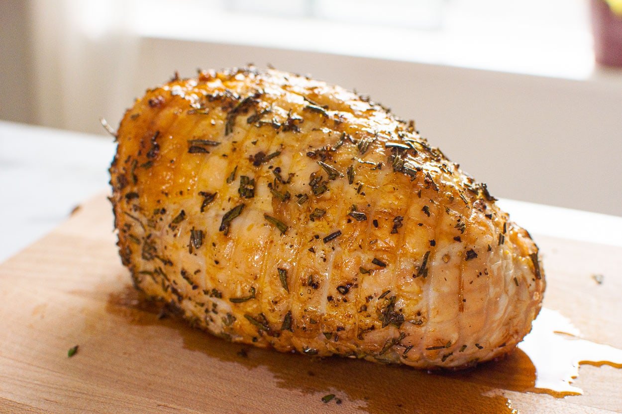 Boneless turkey breast roast on cutting board.