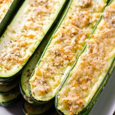 Parmesan zucchini sticks stacked on top of each other.