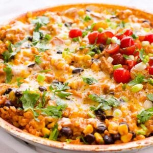 Chicken burrito skillet in one pan topped with cheese and cilantro.