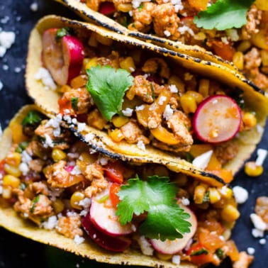 Ground chicken tacos with vegetables and mexican spices served in corn tortillas.