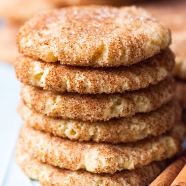 gluten free snickerdoodles cookies stacked up with cinnnamon stick