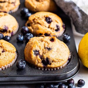 Healthy lemon blueberry muffins in a muffin tin.