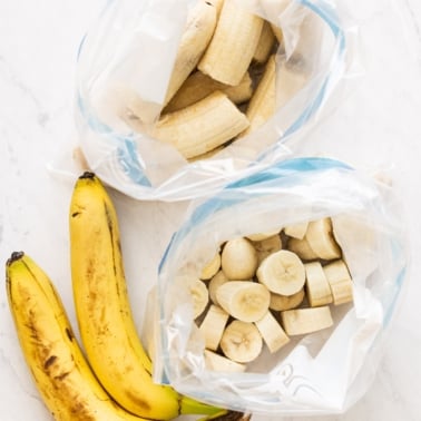 Frozen sliced bananas and half bananas in freezer bags. Two bananas.