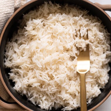 Instant pot basmati rice served in black bowl with a fork.