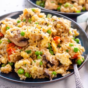 Instant pot chicken fried rice served on a plate with a fork.