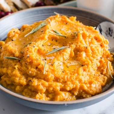 Healthy mashed sweet potatoes in a blue bowl.