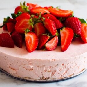 Healthy no bake strawberry cheesecake with fresh strawberries on top.
