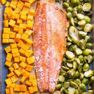 One pan salmon with brussels sprouts and butternut squash on baking sheet.