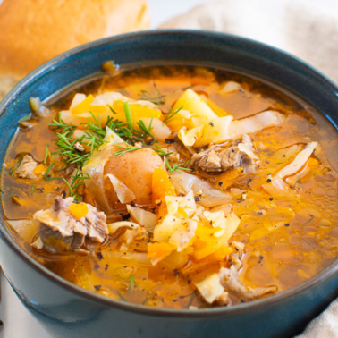 russian shchi cabbage soup in a bowl with garnish
