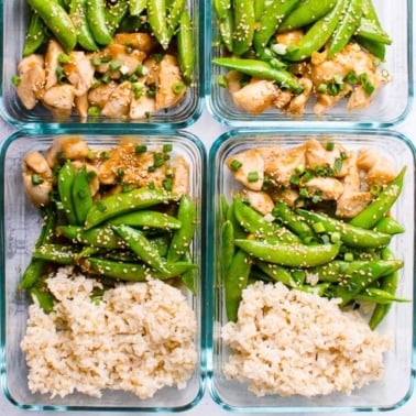 Four glass containers with teriyaki chicken meal prep rice, chicken and snap peas.