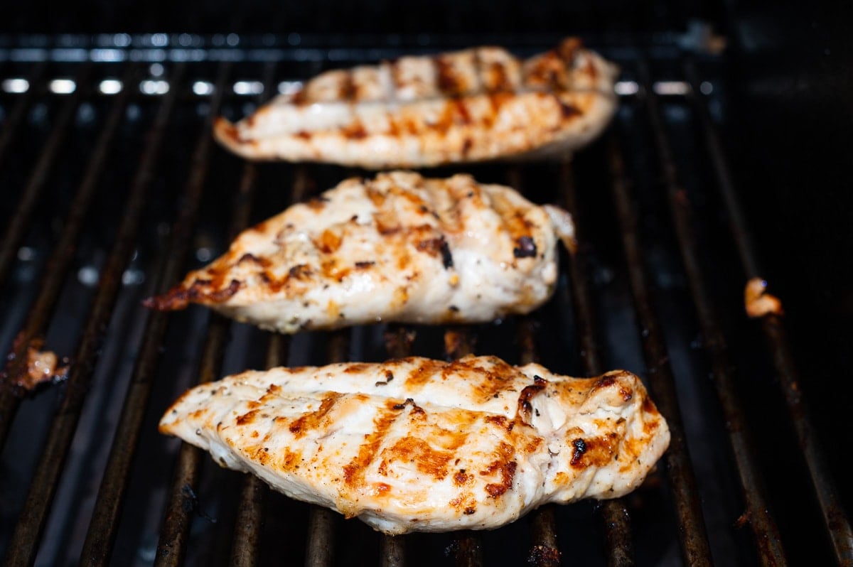 Grilled chicken on barbecue grill.