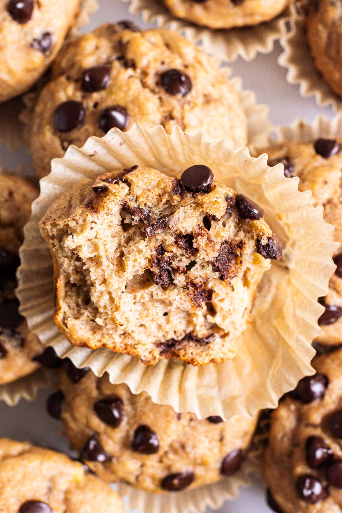 Healthy banana chocolate chip muffins with a bite taken out of.