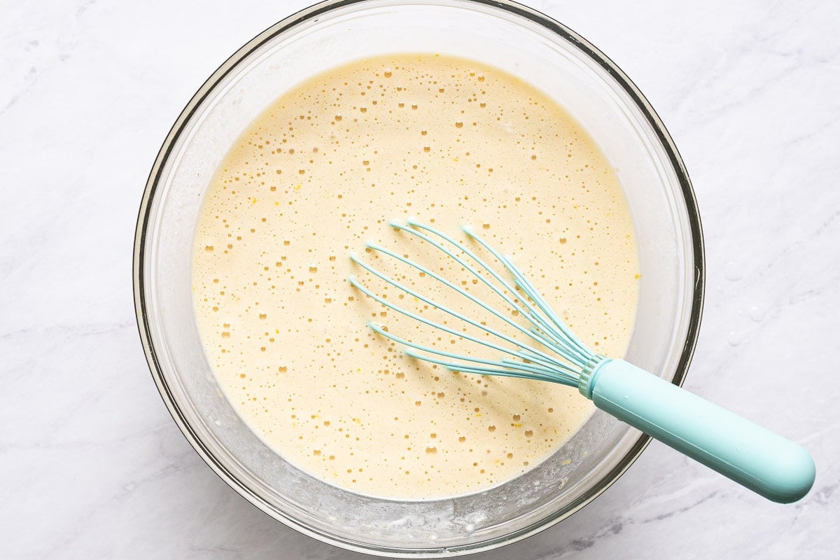 Liquid ingredients whisked in a bowl.