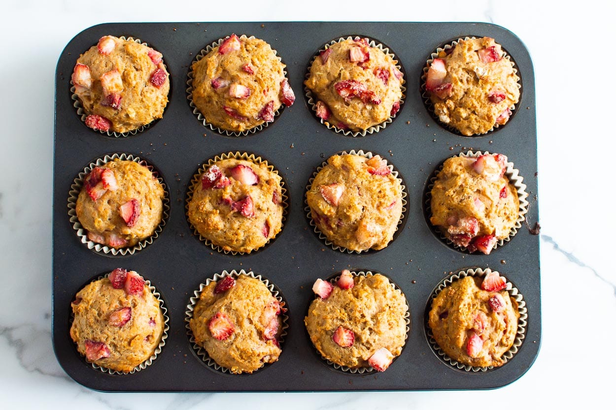 Baked healthy strawberry muffins in a tin.