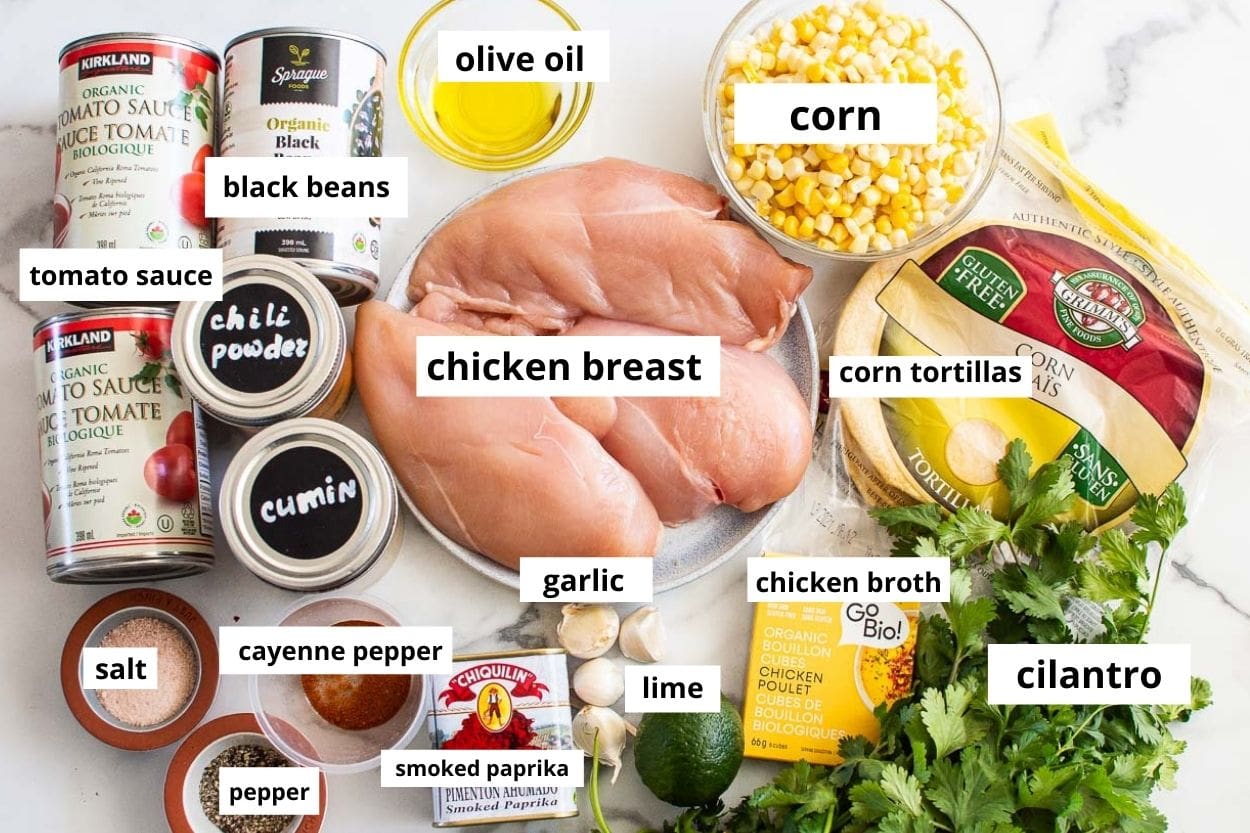 Chicken breasts, black beans, tomato sauce, corn, corn tortillas, oil, chicken broth, lime, cilantro, and spices.