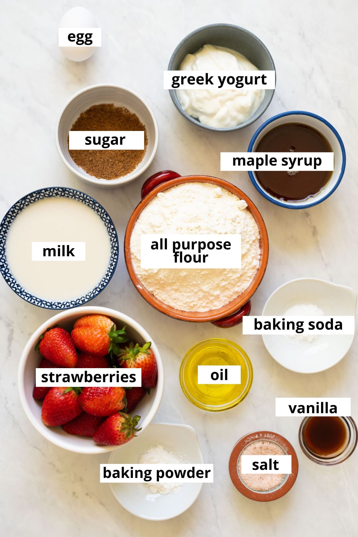 Strawberries, egg, milk, Greek yogurt, all purpose flour, maple syrup, sugar, baking soda, baking powder, oil, vanilla, salt.