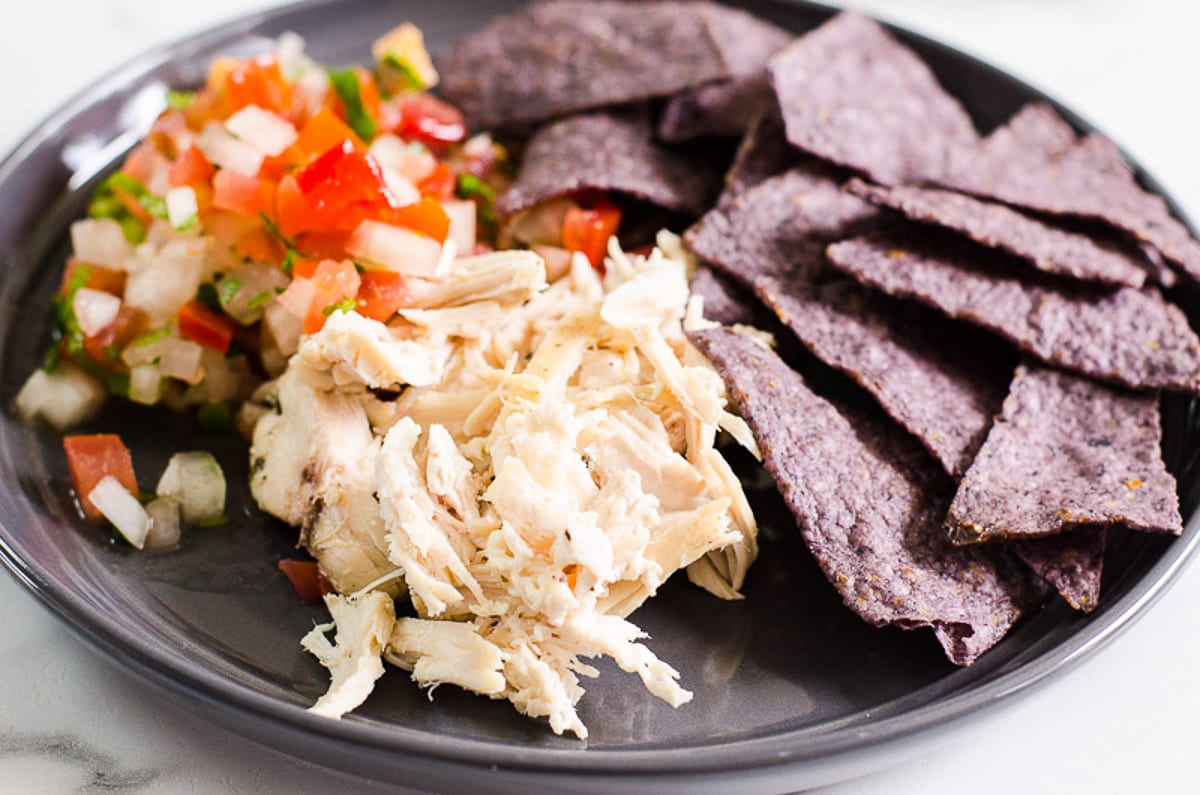 Instant Pot chicken breast, pico de gallo and tortilla chips served on blue plate.