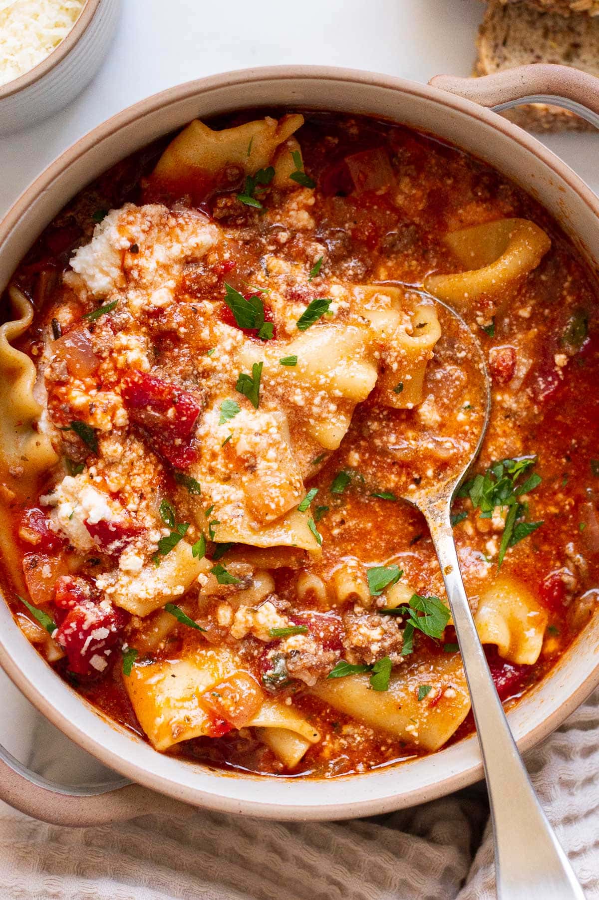 Instant pot lasagna soup in a bowl with a spoon.