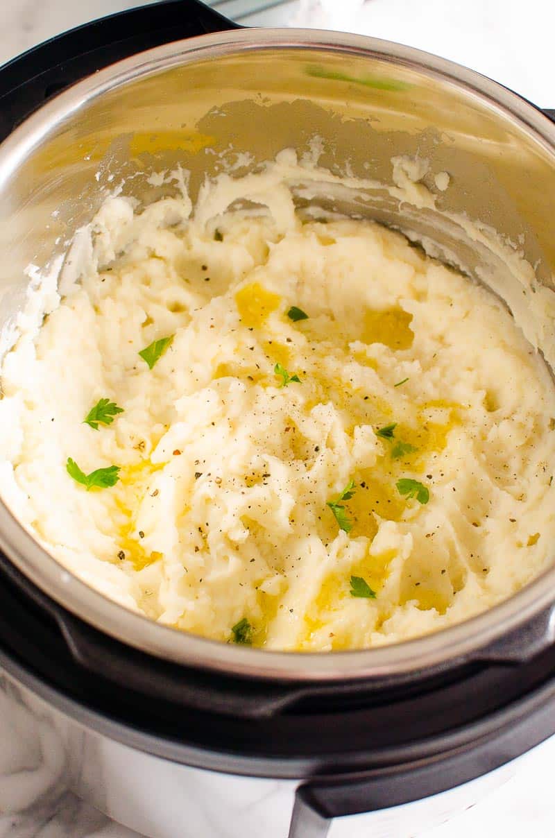 mashed potatoes in instant pot garnished in black pepper and parsley
