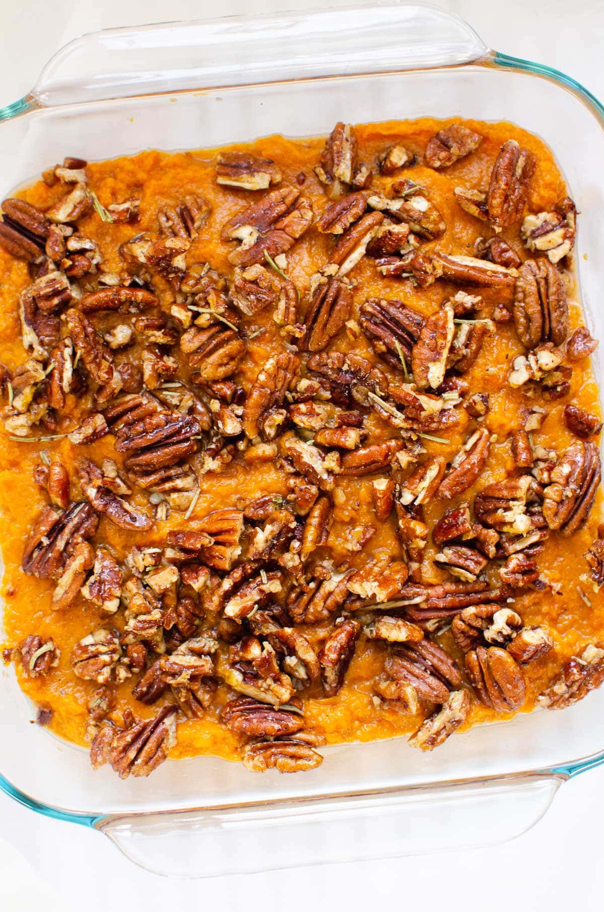 Instant pot sweet potato casserole with pecan topping in glass baking dish.