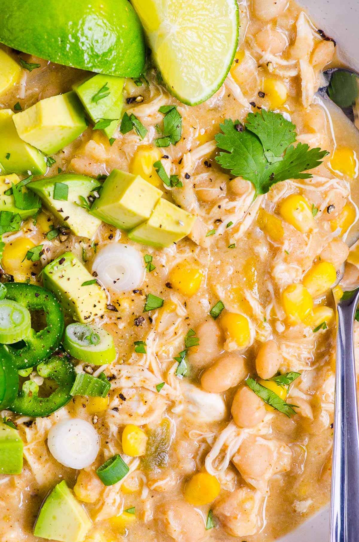 Instant Pot White Chicken Chili garnished with avocado, cilantro, green onion and jalapenos.