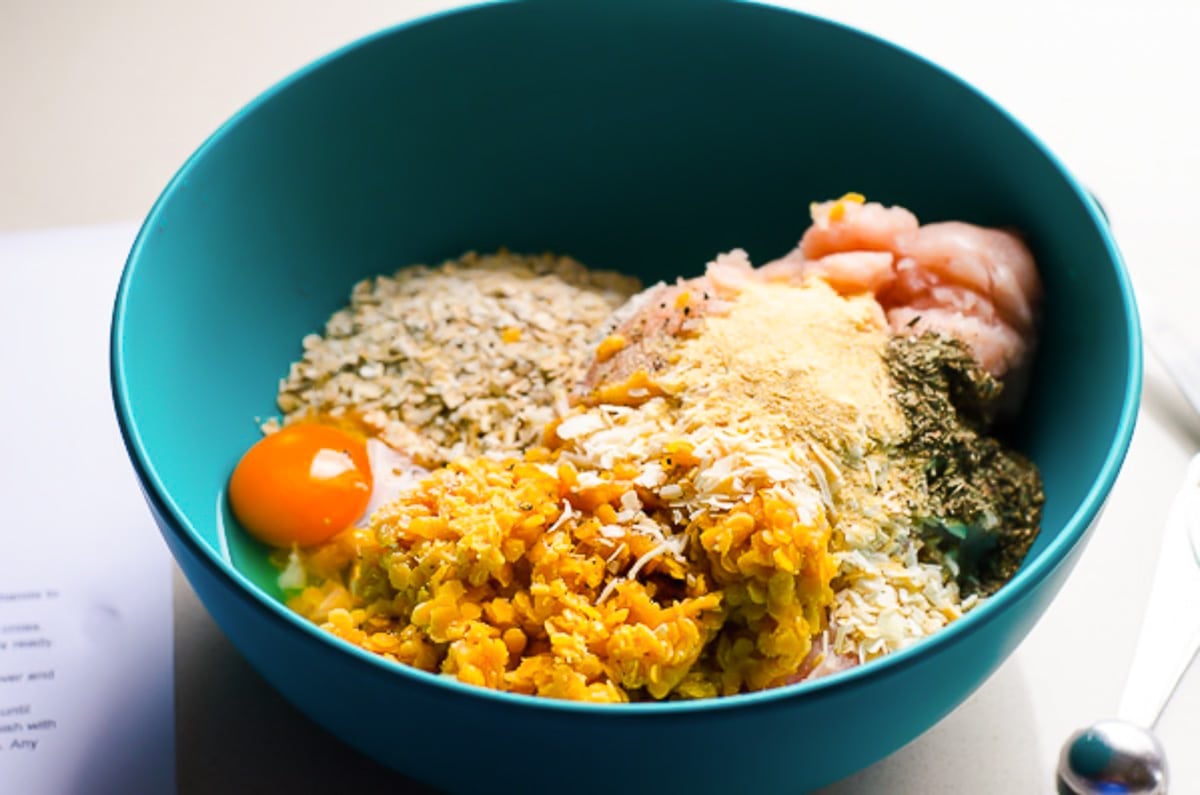 Eggs, lentils, spices, turkey, oats in blue bowl.
