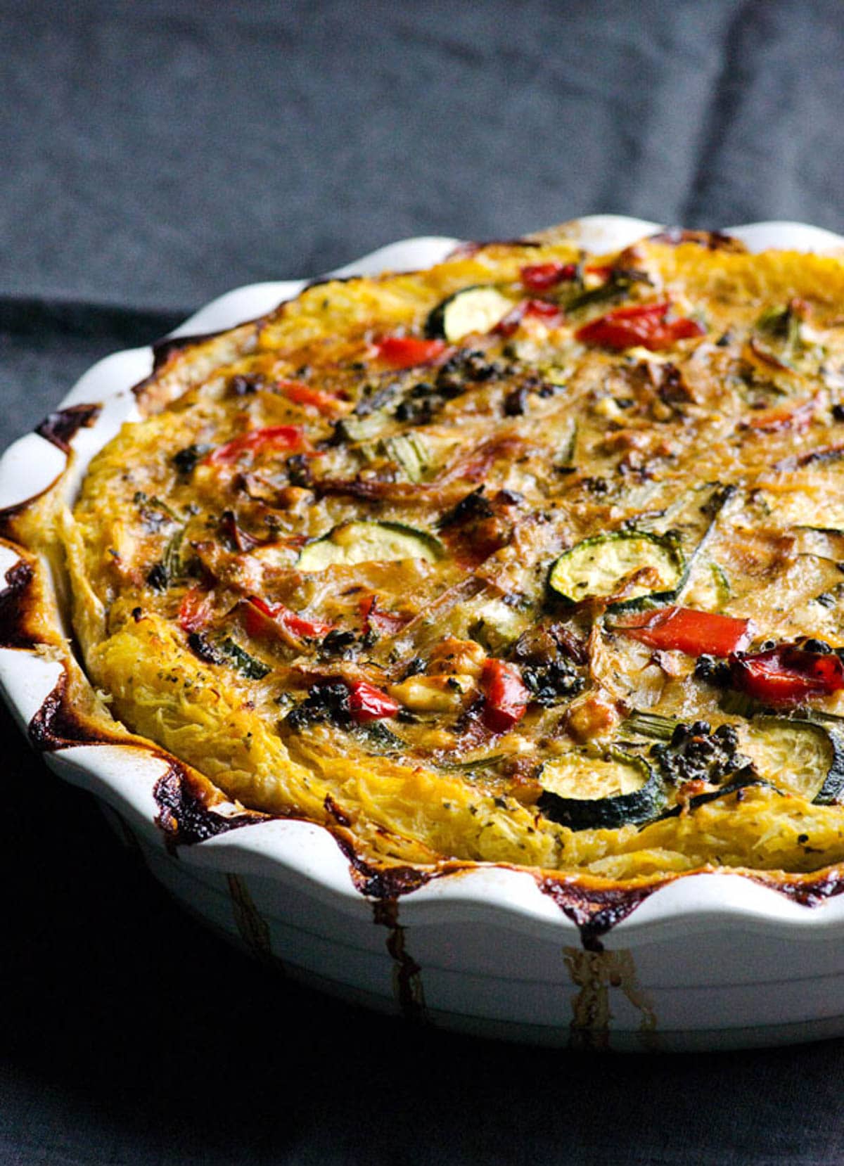 Spaghetti squash quiche with vegetables in a pie baking dish.