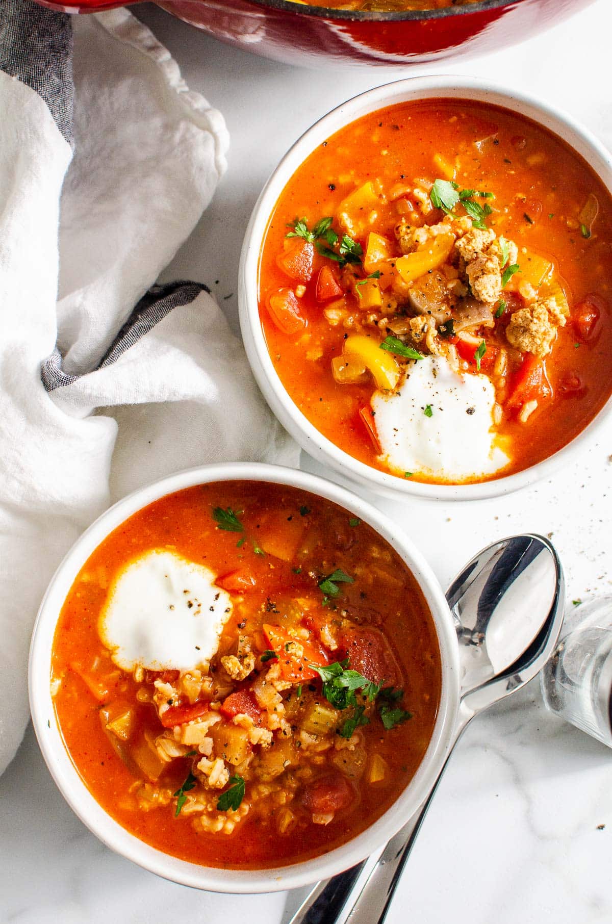 Instant Pot stuffed pepper soup served in bowls with sour cream.